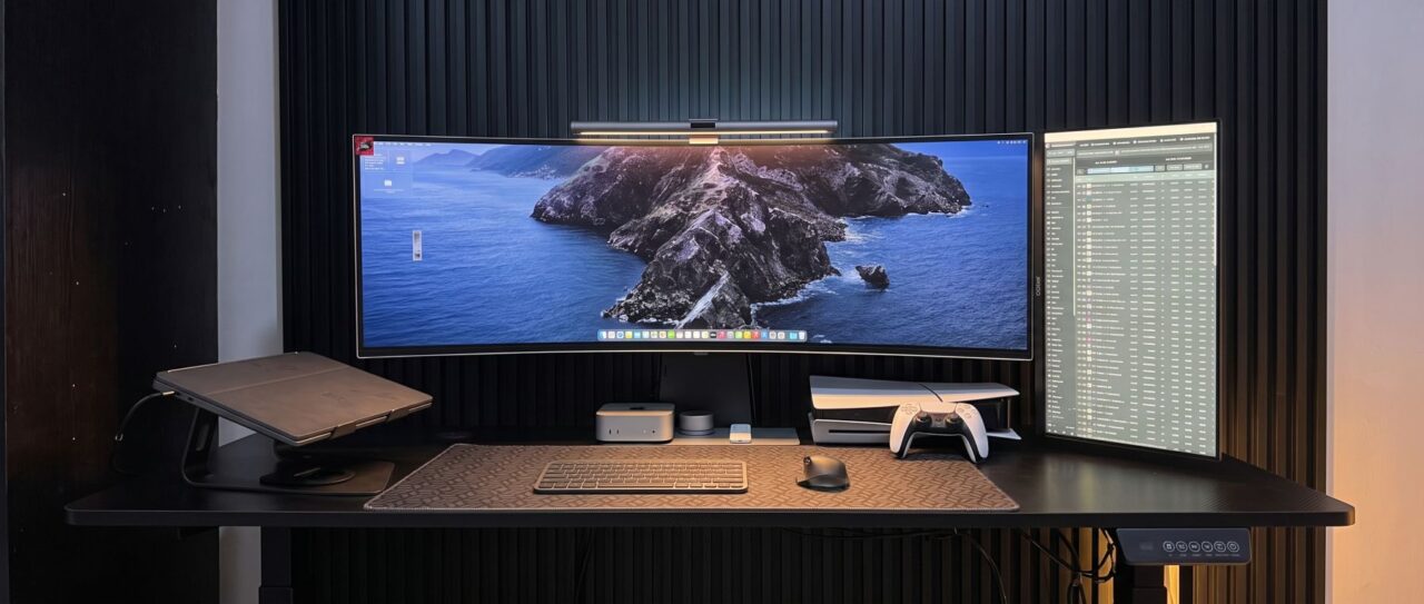 Ultrawide monitor and vertical display on a black desk